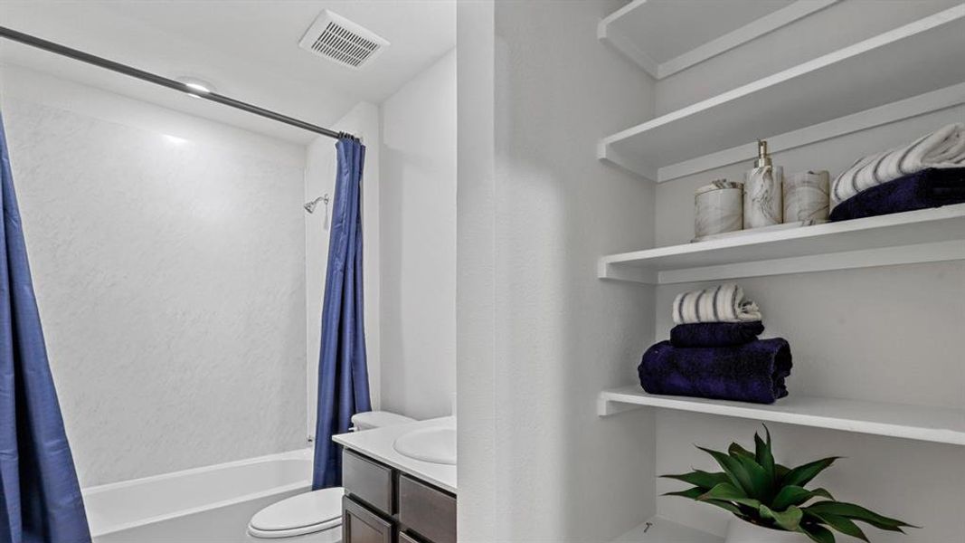 Full bathroom featuring vanity and shower / bath combo with shower curtain Full bathroom featuring vanity and shower / bath combo with shower curtain