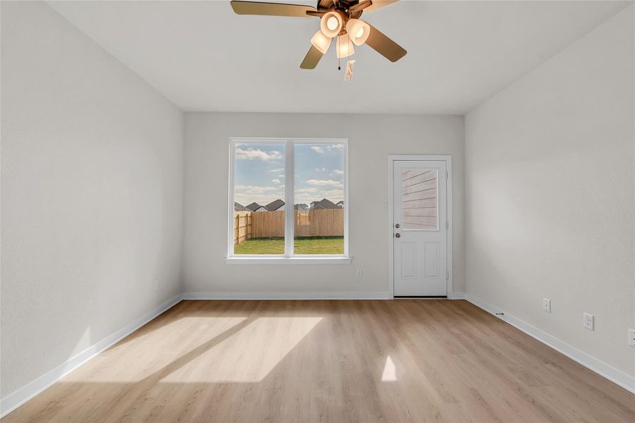 Spare room featuring light wood finished floors and ceiling fan