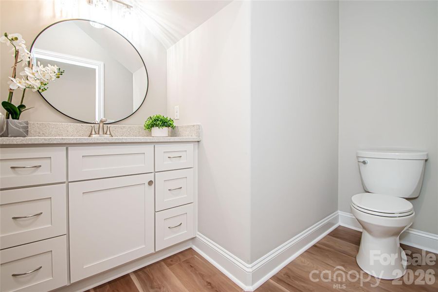 A conveniently located main-level powder room adds ease for guests and everyday use.