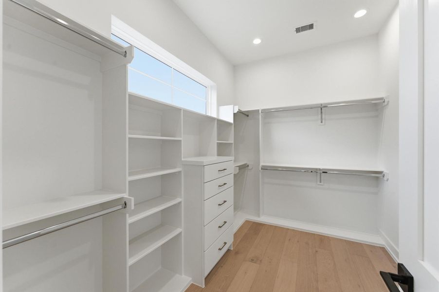 Huge primary closet with built-in dresser.