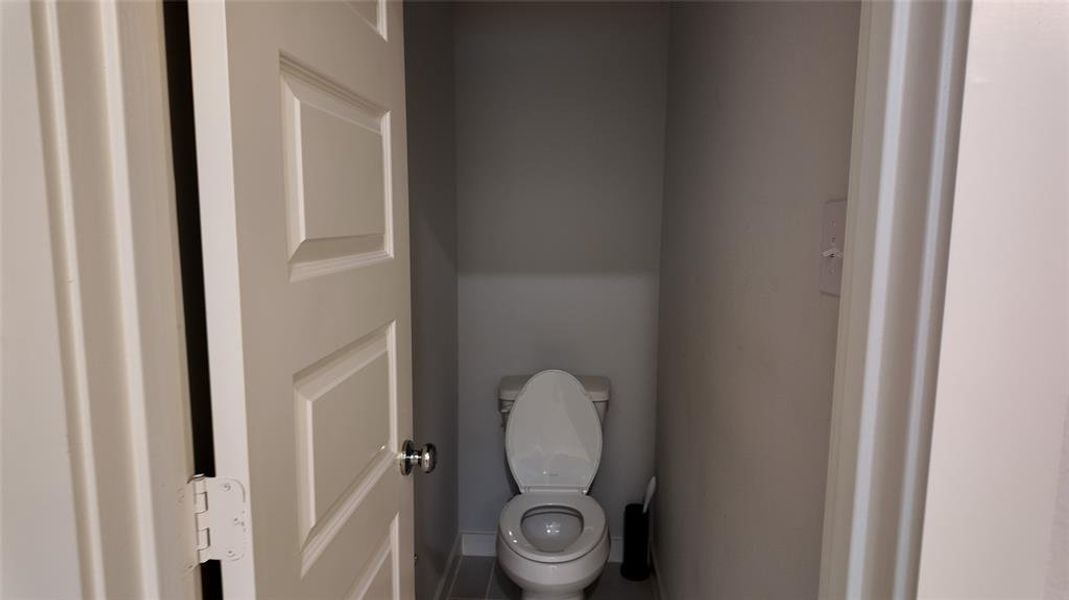 The property includes a toilet with a white seat and a tiled floor