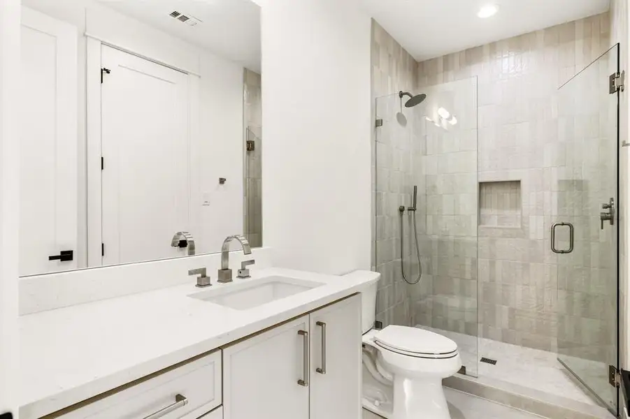 Bathroom featuring vanity, a shower stall, and recessed lighting Bathroom featuring vanity, a shower stall, and recessed lighting