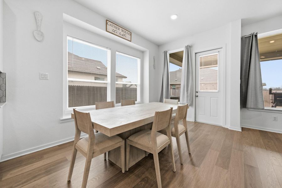 Dining space with light wood-type flooring and baseboards