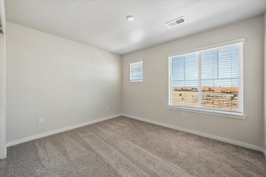 A room with a window and a carpet.