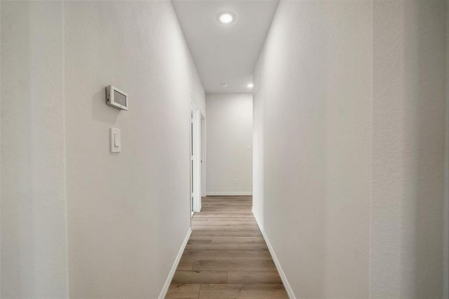Corridor featuring recessed lighting and light wood-style floors