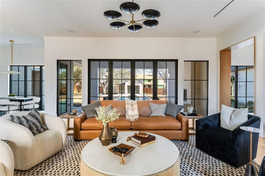 Living room featuring ornamental molding and a chandelier