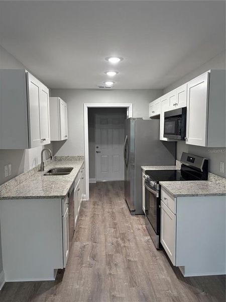 Living Room looking into Kitchen/Laundry Room