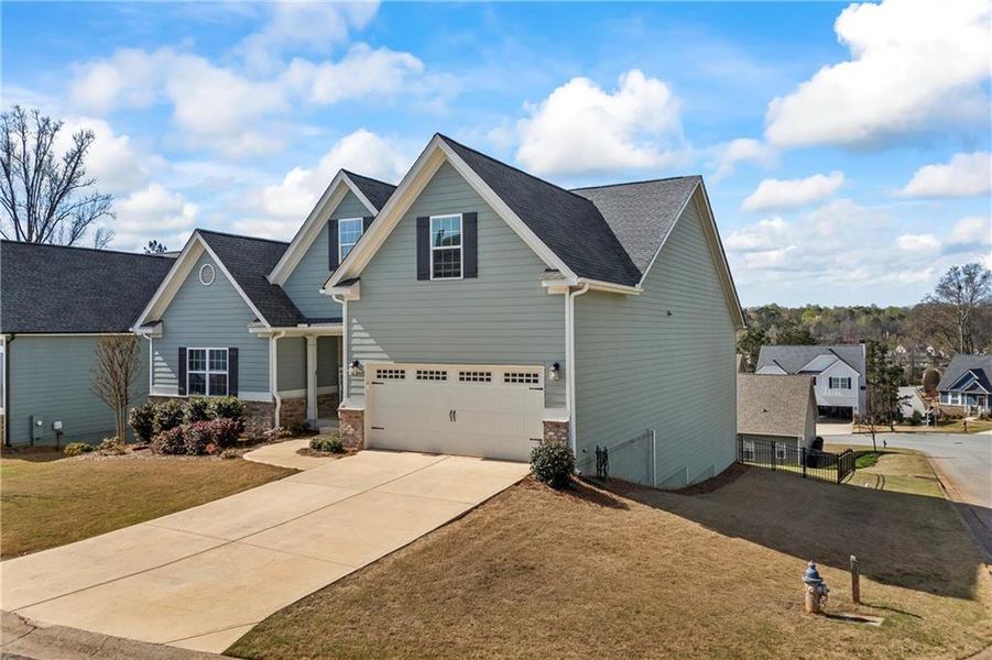 Front exterior of a new home in Traditions of Braselton, Jefferson, GA, highlighting curb appeal (Image 24). Front exterior of a new home in Traditions of Braselton, Jefferson, GA, highlighting curb appeal (Image 24).