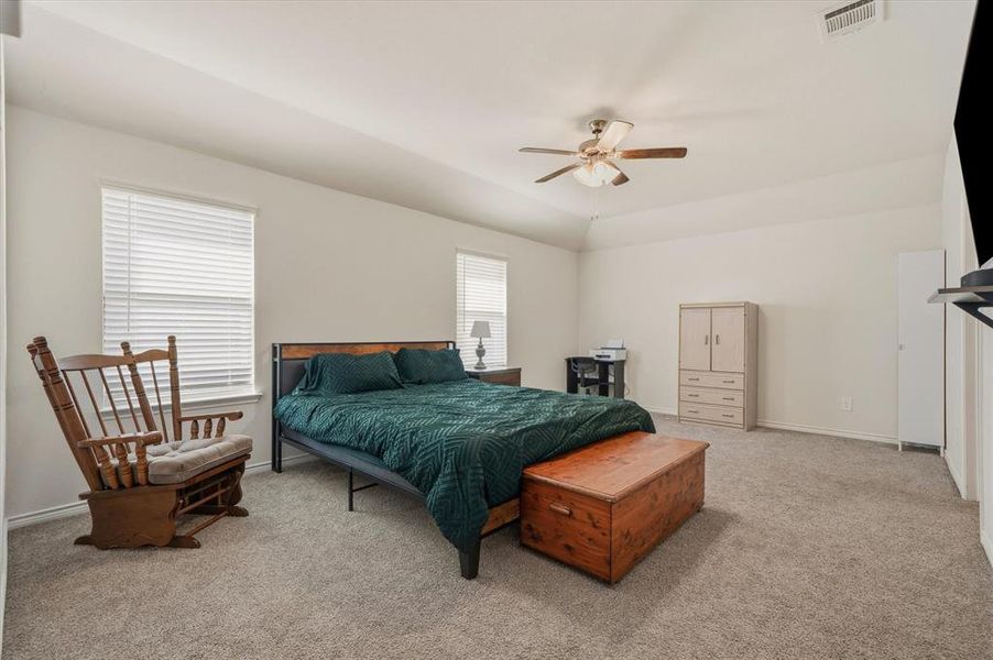 Bedroom with light colored carpet and a ceiling fan Bedroom with light colored carpet and a ceiling fan
