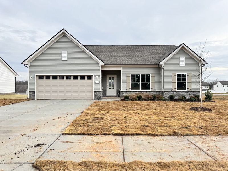 Front exterior of a new home in Wheatfield, Shelbyville, TN, highlighting curb appeal (Image 1).
