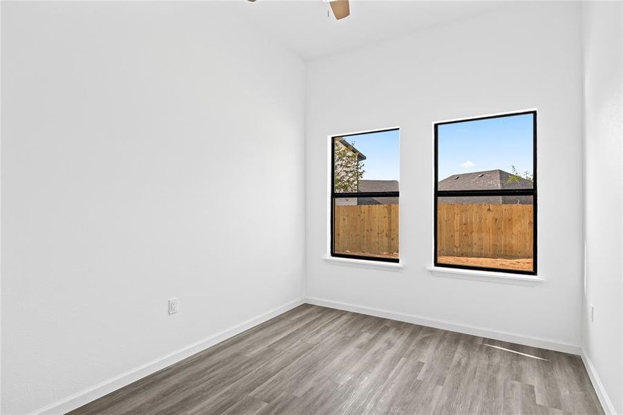 Unfurnished room with light wood-type flooring and ceiling fan