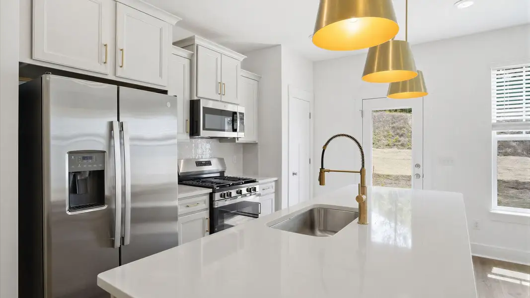 Superior craftsmanship shines in this modern kitchen with a space-saving island and open flow at the Marion Square community