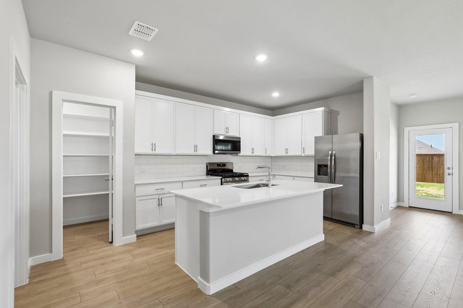 Kitchen in the Oscar home plan by Trophy Signature Homes