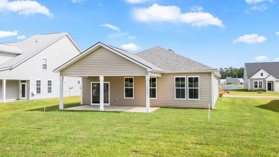 Rear exterior features a spacious covered porch and level backyard. Rear exterior features a spacious covered porch and level backyard.