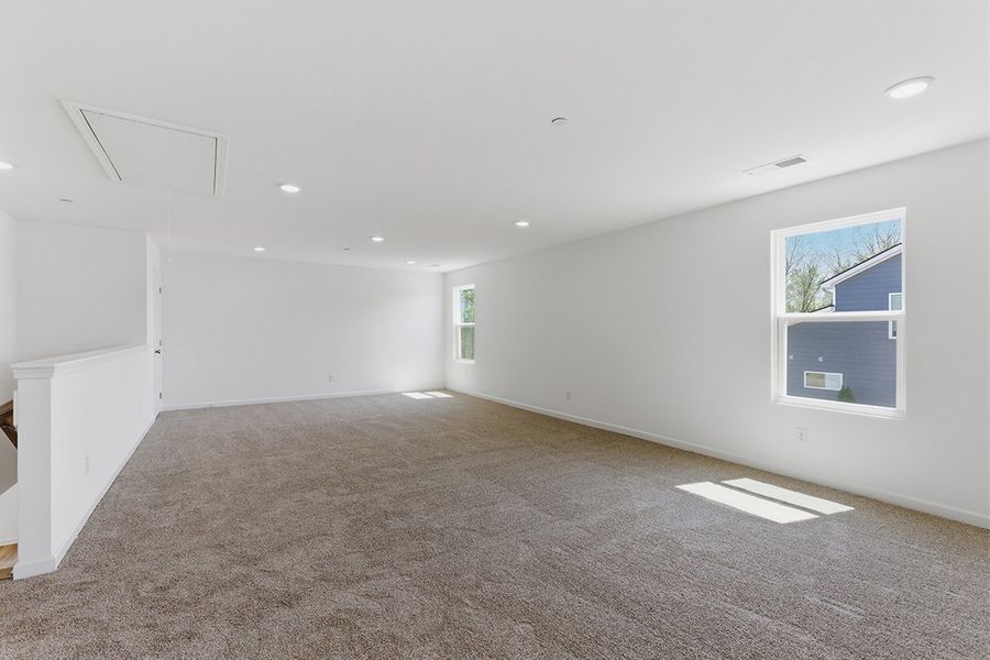 A room with a carpet and windows. A room with a carpet and windows.