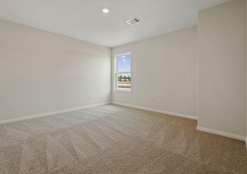 Secondary bedroom with lush carpet flooring