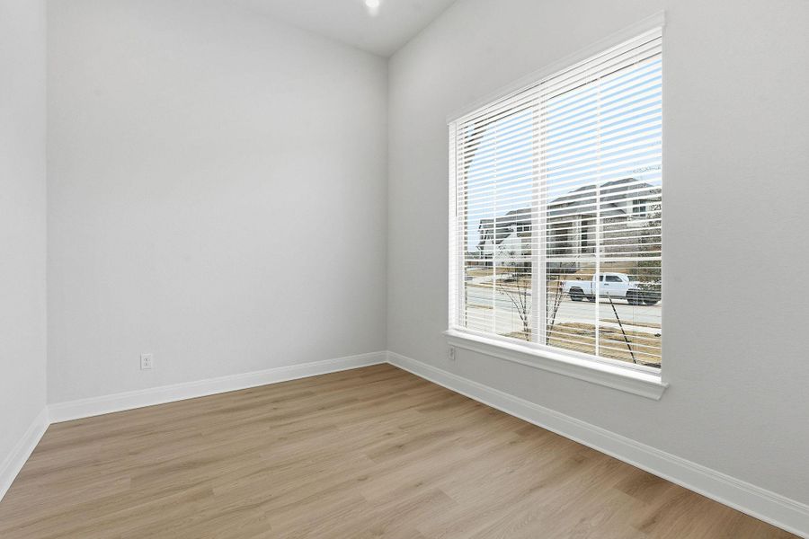 Spare room with light wood-style flooring and baseboards