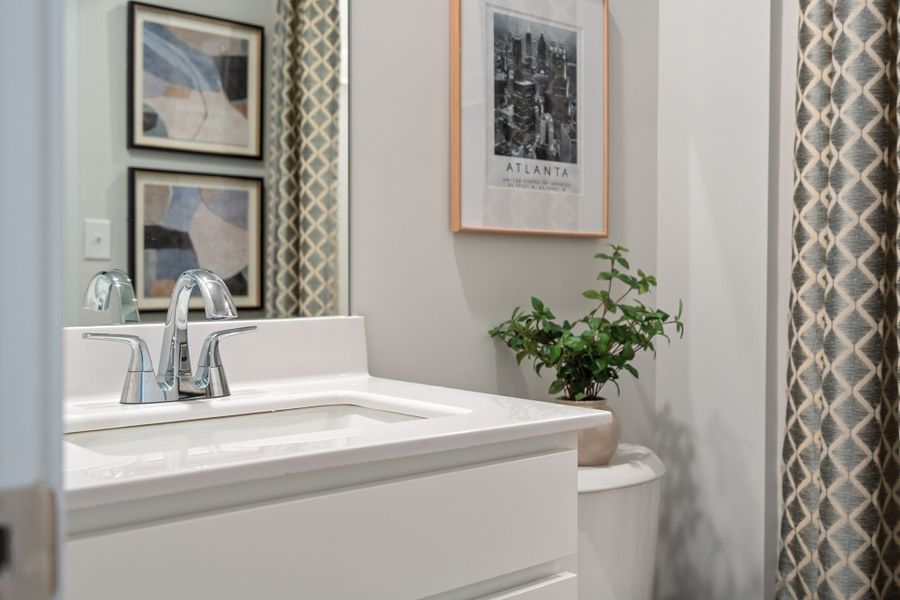 A bathroom with a sink and a plant. A bathroom with a sink and a plant.