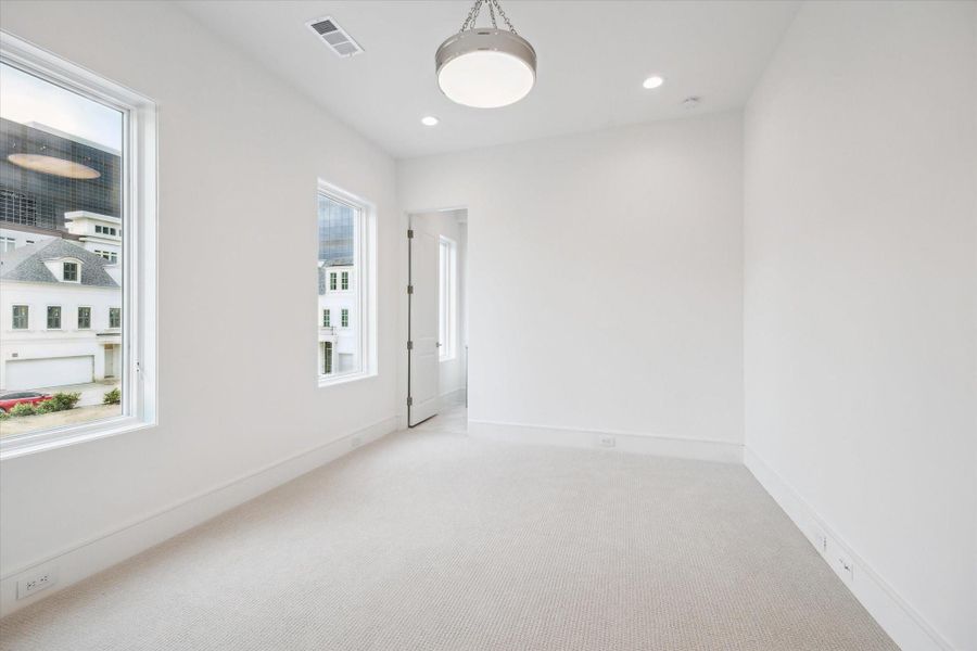 The final second-floor bedroom featuresShaw high-performance carpet from their Aerial Collection and Z-Lite semi flush-mount chandelier. The final second-floor bedroom featuresShaw high-performance carpet from their Aerial Collection and Z-Lite semi flush-mount chandelier.