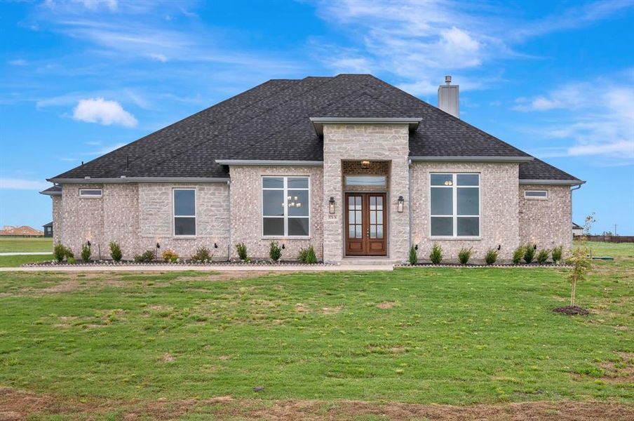 Prairie-style house with a front lawn, stone siding, french doors, a chimney, and a shingled roof Prairie-style house with a front lawn, stone siding, french doors, a chimney, and a shingled roof