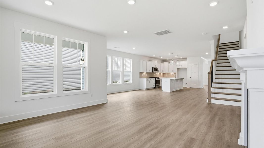 Spacious family room with rich hardwood flooring and elegant trim work in a reputable DRB Homes build
