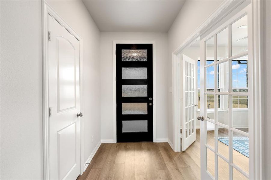 Entryway featuring light wood finished floors and french doors