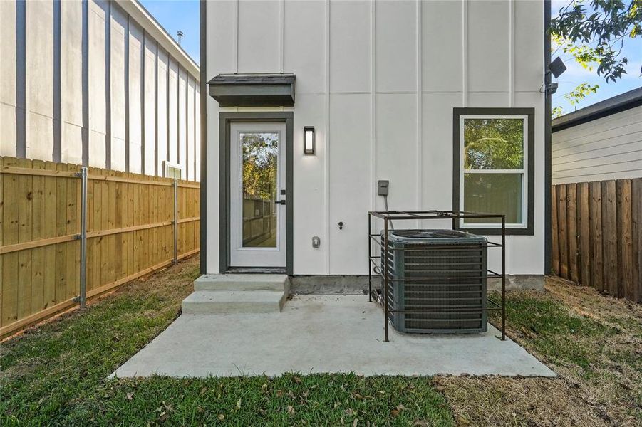 Property entrance with board and batten siding and a patio area Property entrance with board and batten siding and a patio area