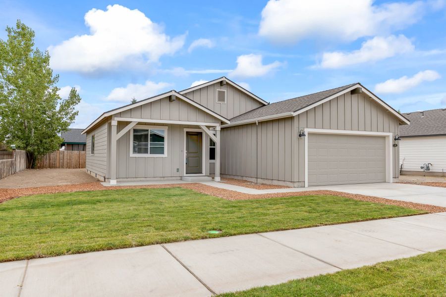 Front exterior of a new home in Willowbrook, Madras, OR, highlighting curb appeal (Image 1). Front exterior of a new home in Willowbrook, Madras, OR, highlighting curb appeal (Image 1).