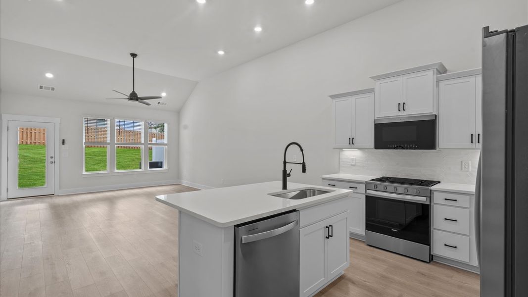 Modern vaulted ceiling kitchen in two story townhome at Aspen Ridge by DRB Homes in Lyman, SC Modern vaulted ceiling kitchen in two story townhome at Aspen Ridge by DRB Homes in Lyman, SC