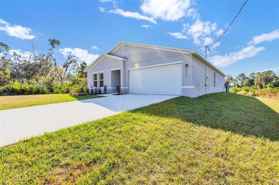 Front exterior of a new home in Palm Bay Classic, Palm Bay, FL, highlighting curb appeal (Image 12).