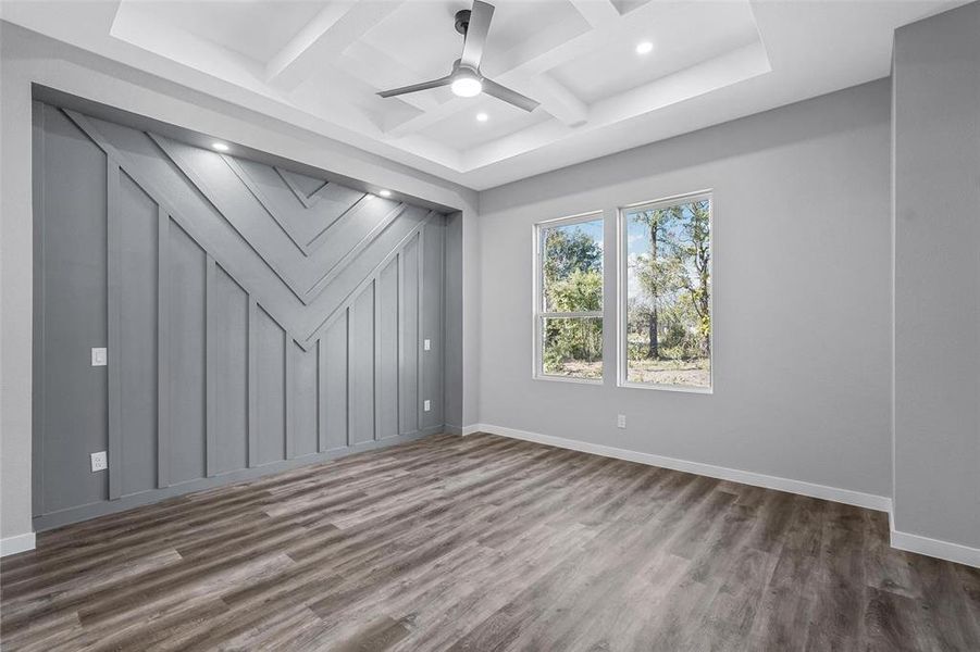 Unfurnished room with beamed ceiling, dark hardwood / wood-style floors, ceiling fan, and coffered ceiling