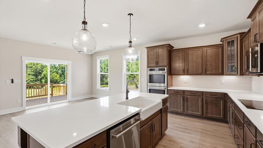 First-rate kitchen with functional layout, designer pendant lighting, and a large center island located in Woodruff, SC