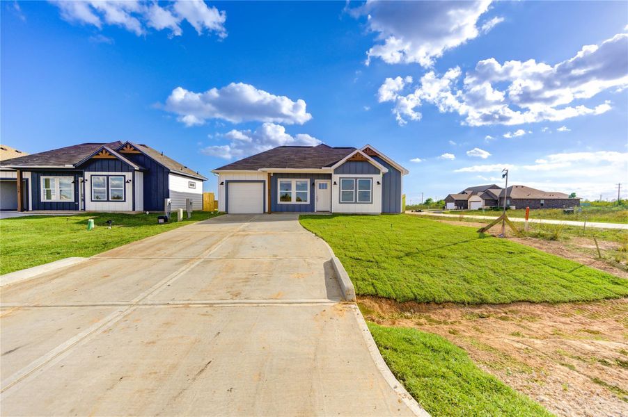 Front exterior of a new home in , Cleveland, TX, highlighting curb appeal (Image 24).