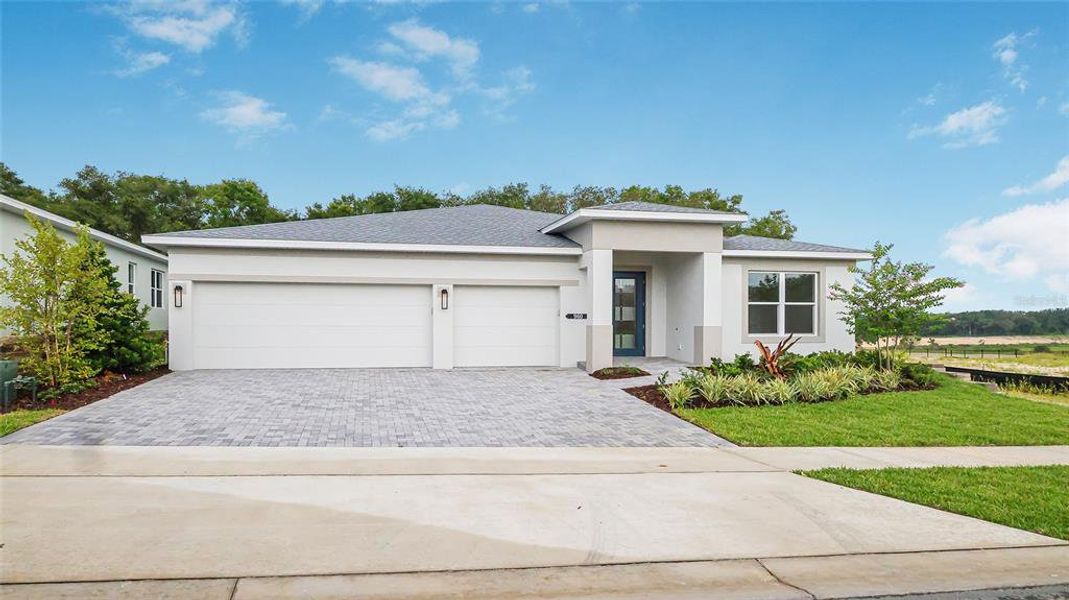 Front exterior of a new home in Cresswind at Hammock Oaks, Lady Lake, FL, highlighting curb appeal (Image 1). Front exterior of a new home in Cresswind at Hammock Oaks, Lady Lake, FL, highlighting curb appeal (Image 1).