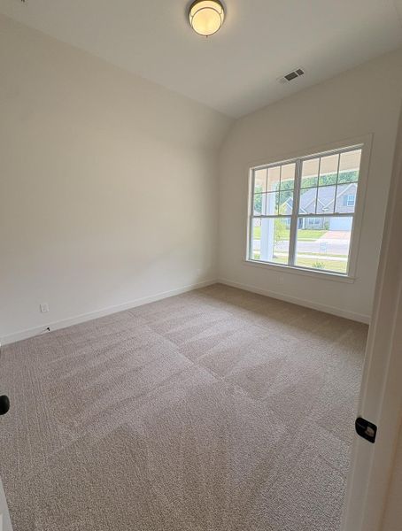 Neutral-toned carpeting covering the floor