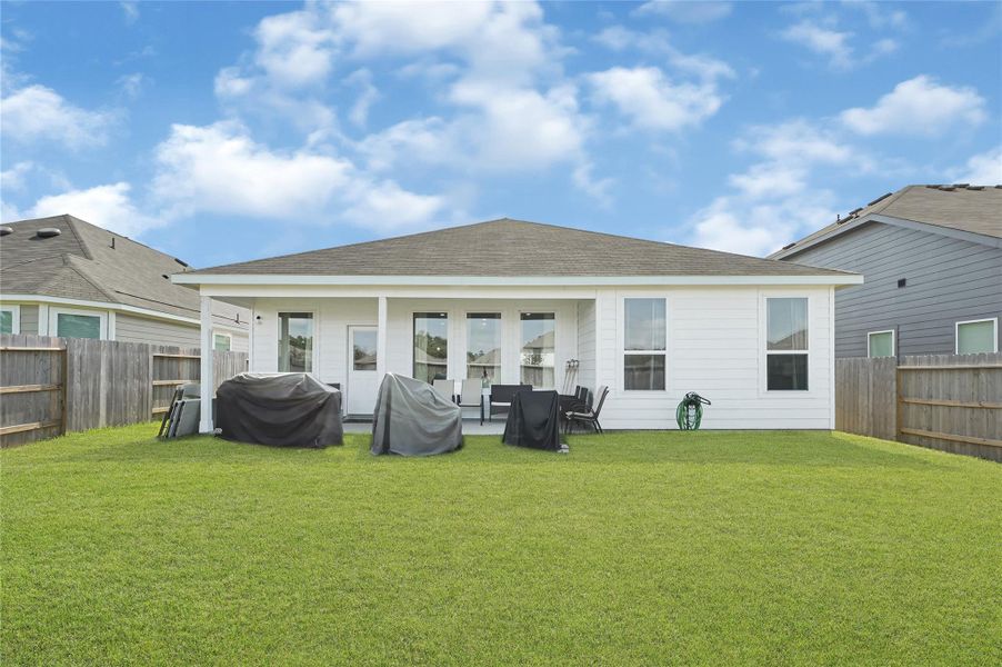 Charming backyard features a spacious covered patio, perfect for outdoor entertaining, with a well-maintained lawn surrounded by privacy fencing. Charming backyard features a spacious covered patio, perfect for outdoor entertaining, with a well-maintained lawn surrounded by privacy fencing.