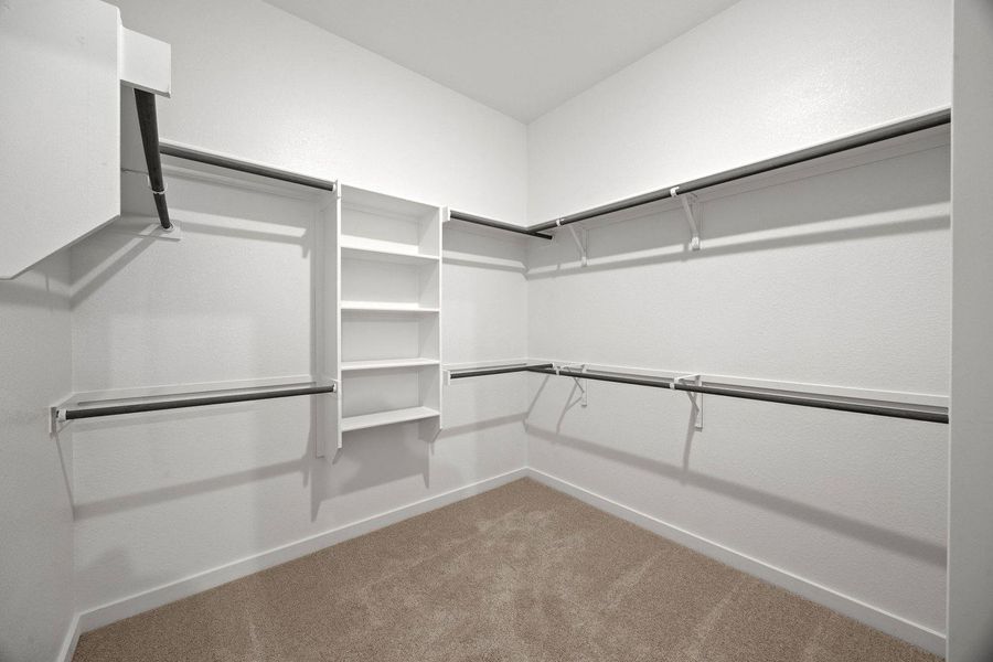Ample shelving and hanging rods offer versatile storage in this well-appointed closet.
