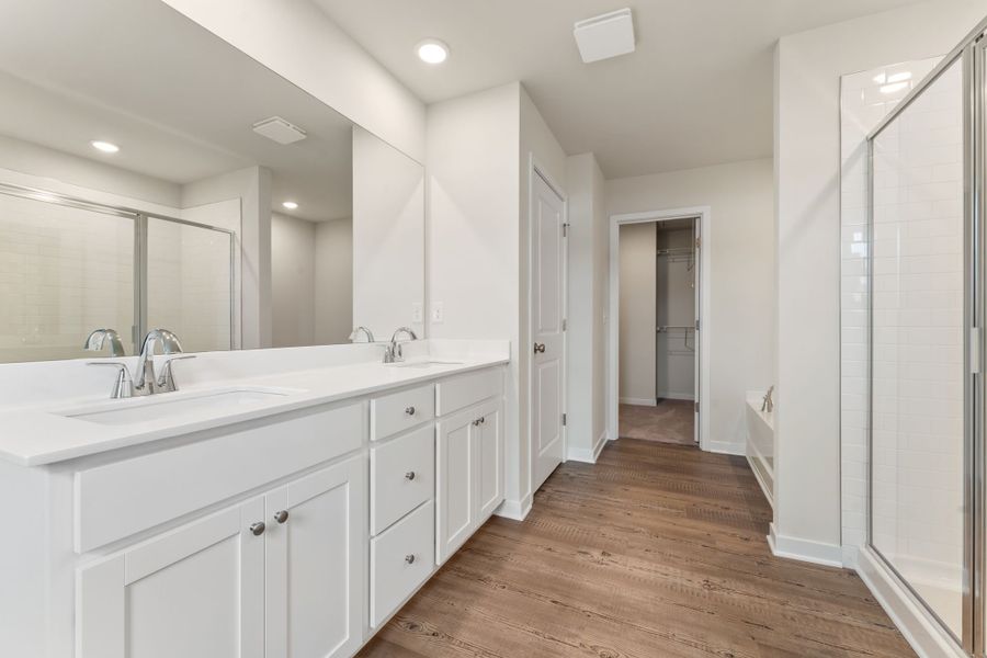 A bathroom with white cabinets.