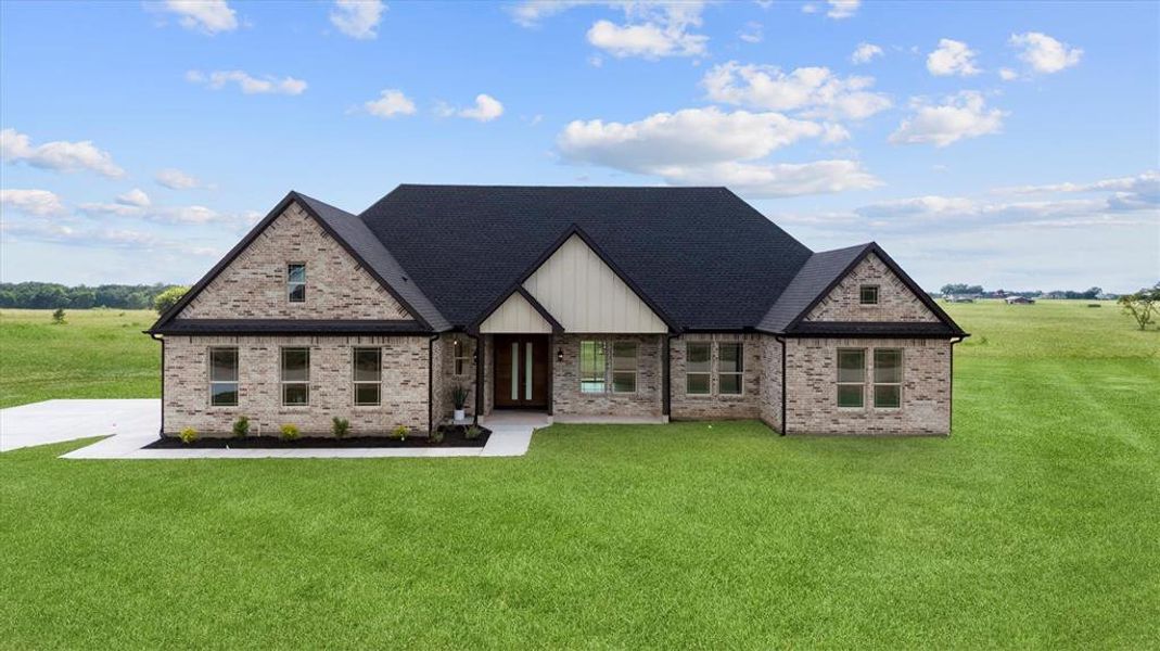 View of front of house featuring a front lawn and brick siding View of front of house featuring a front lawn and brick siding