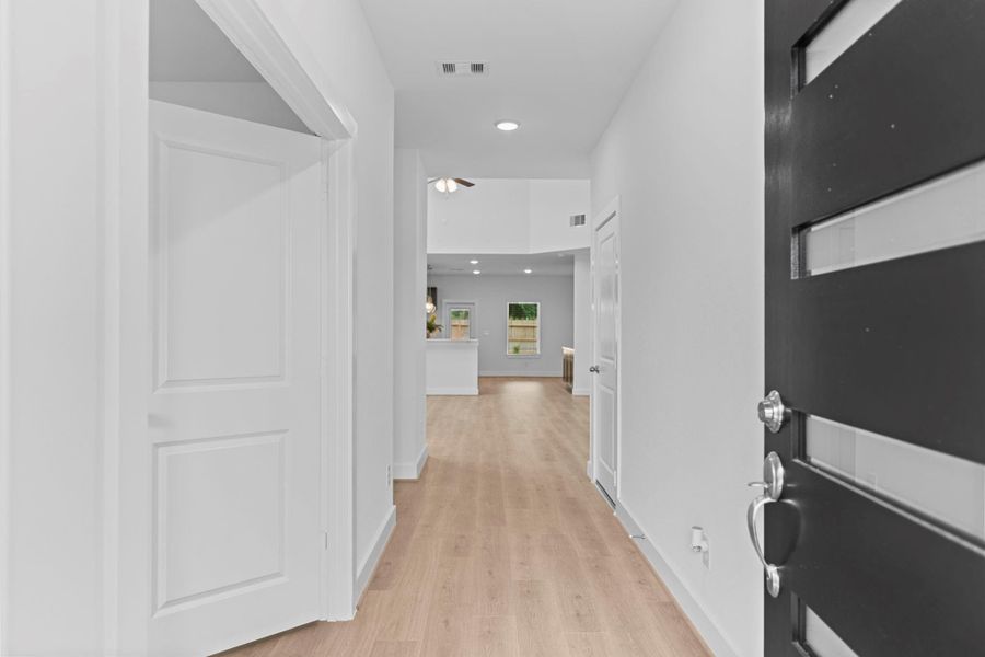 Step into the grand foyer with gorgeous woodlike vinyl plank flooring that flows throughout the main living areas, creating an immediate sense of space, light, and luxury. **Image Representative of Plan Only and May Vary as Built**.