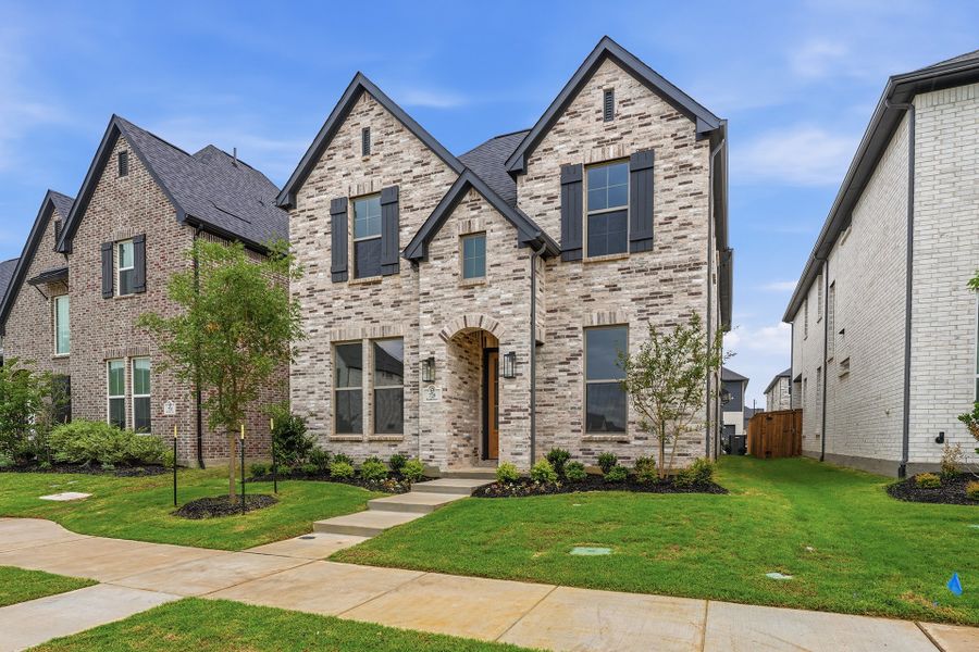 Front exterior of a new home in Light Farms Brenham - 40' Lots, Celina, TX, highlighting curb appeal (Image 26). Front exterior of a new home in Light Farms Brenham - 40' Lots, Celina, TX, highlighting curb appeal (Image 26).