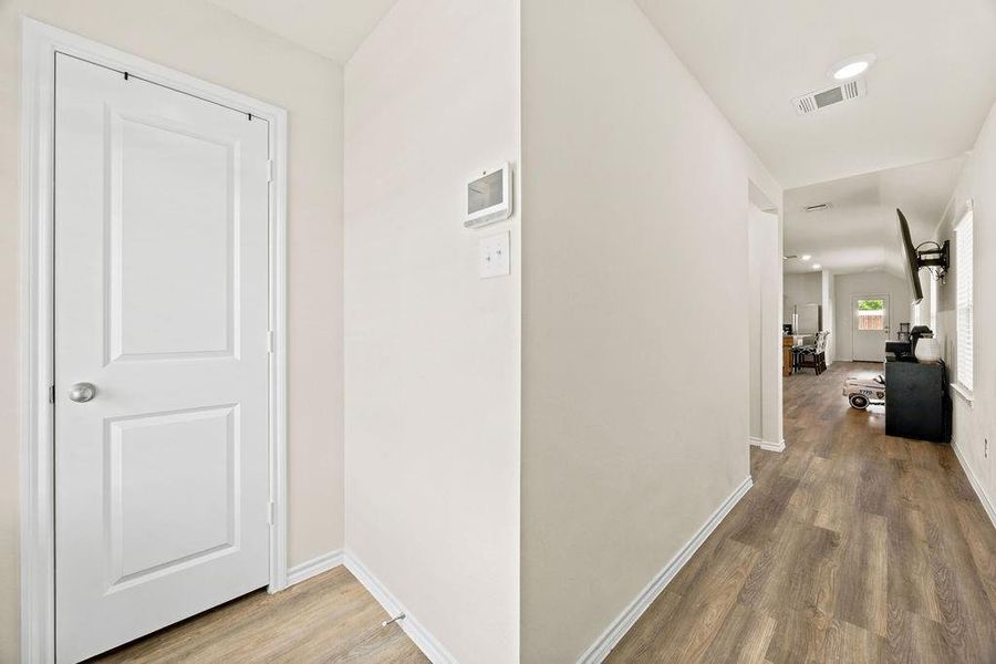 Entryway featuring wood-finish flooring, white baseboards, and neutral wall tones Entryway featuring wood-finish flooring, white baseboards, and neutral wall tones