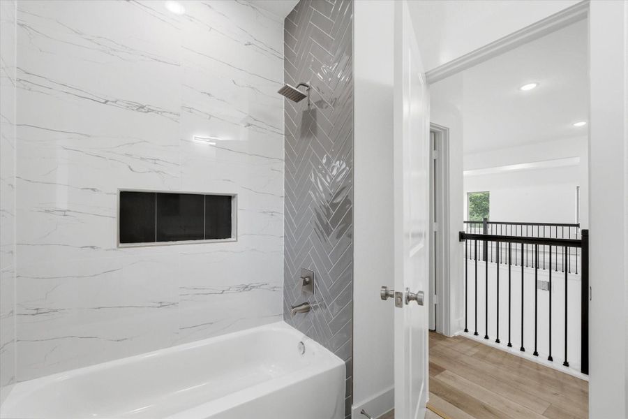 Another upstairs bathroom features a shower/tub combo and plenty of built-in storage. Another upstairs bathroom features a shower/tub combo and plenty of built-in storage.