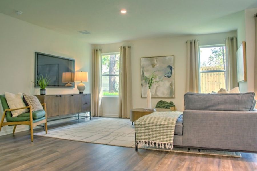 A living room with a large window. A living room with a large window.