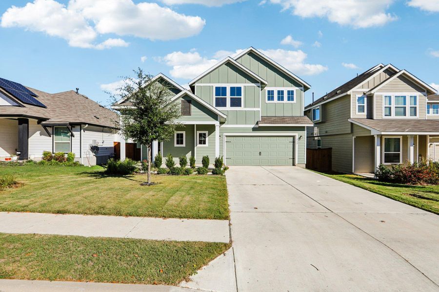 Front exterior of a new home in Orchard Ridge, Liberty Hill, TX, highlighting curb appeal (Image 18).