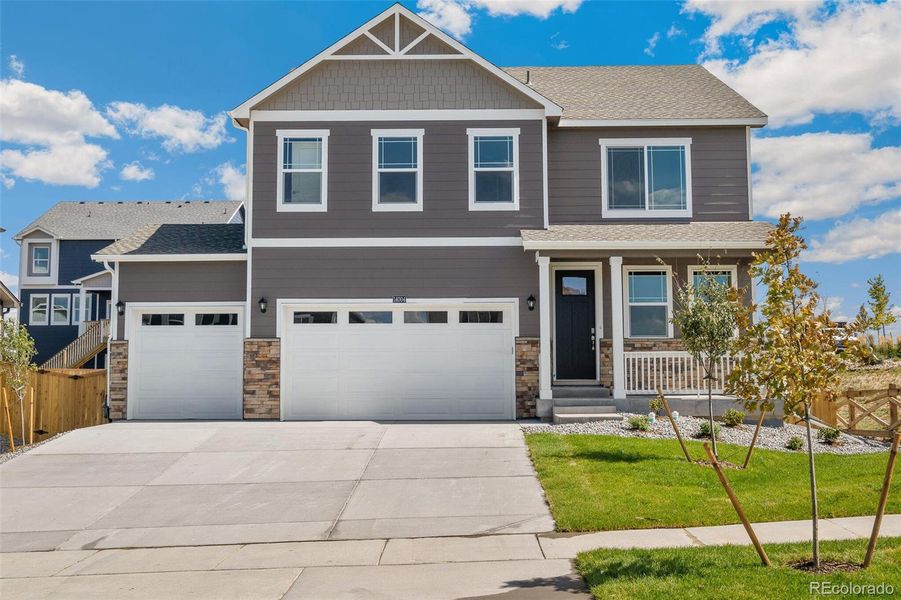 Front exterior of a new home in Trails at Crowfoot, Parker, CO, highlighting curb appeal (Image 1). Front exterior of a new home in Trails at Crowfoot, Parker, CO, highlighting curb appeal (Image 1).