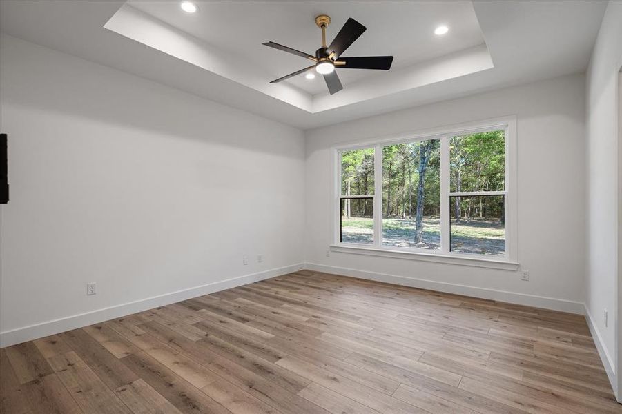 Primary bed room with vaulted ceiling and Luxury flooring