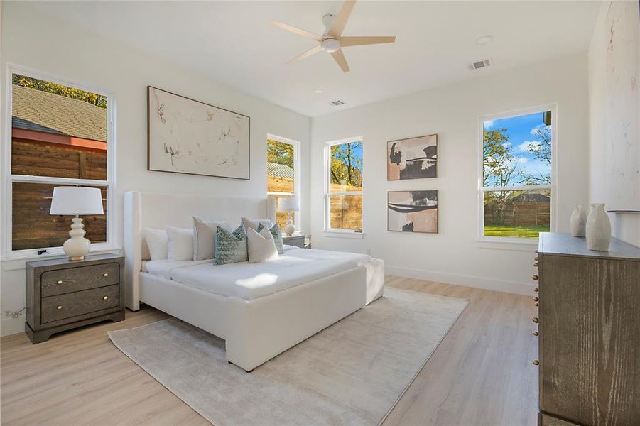 Bedroom with light wood-style floors and ceiling fan Bedroom with light wood-style floors and ceiling fan