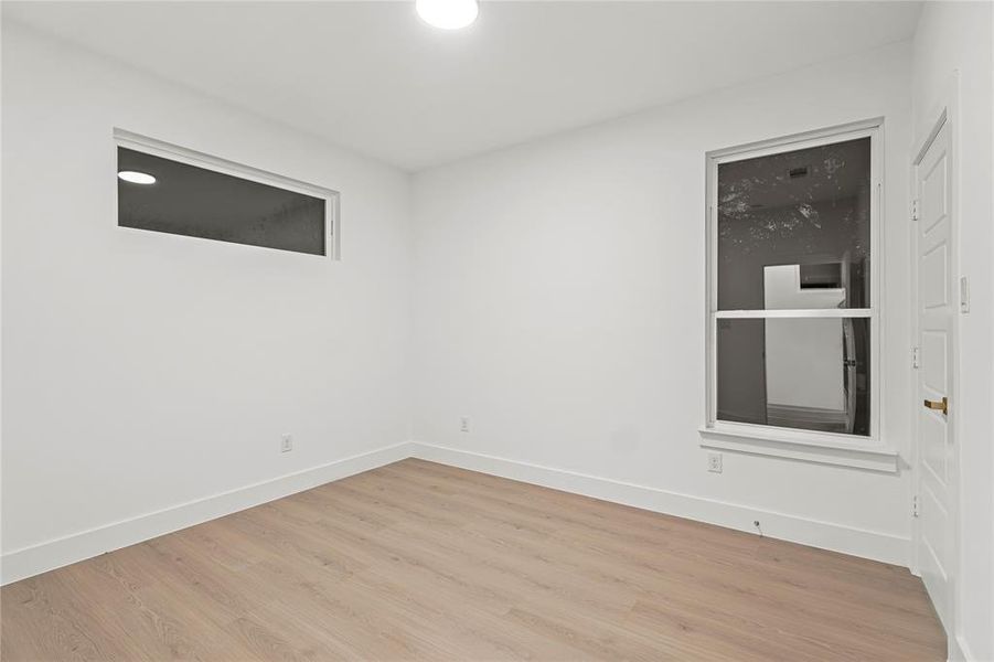Empty room featuring wood finished floors and baseboards