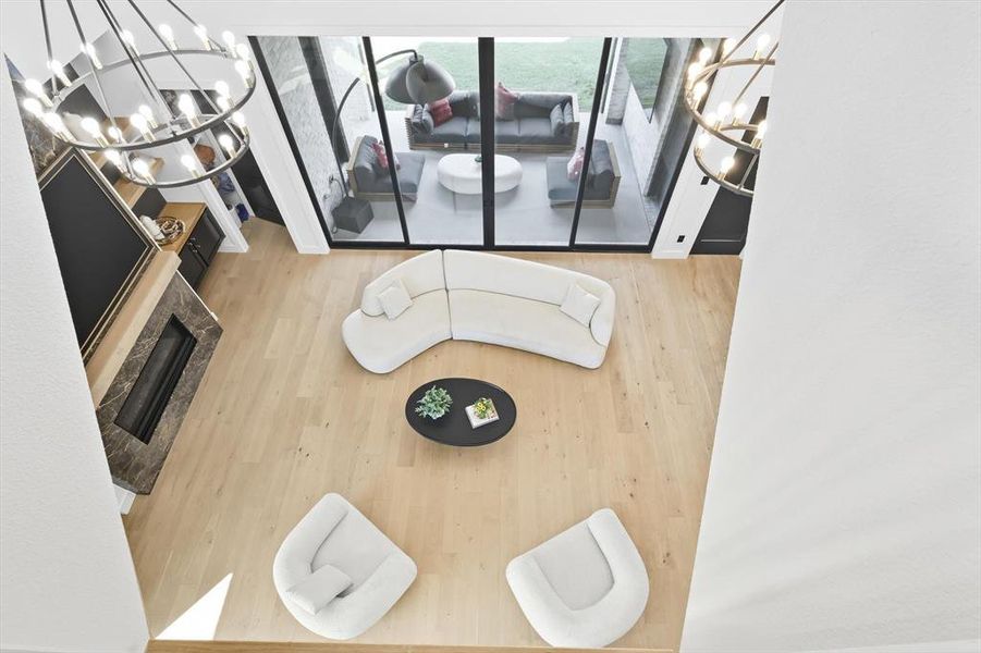Living room featuring a chandelier and light hardwood flooring Living room featuring a chandelier and light hardwood flooring